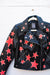 Black leather jacket with hand-painted red and gold stars.