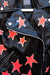 Black leather jacket with hand-painted red and gold stars.