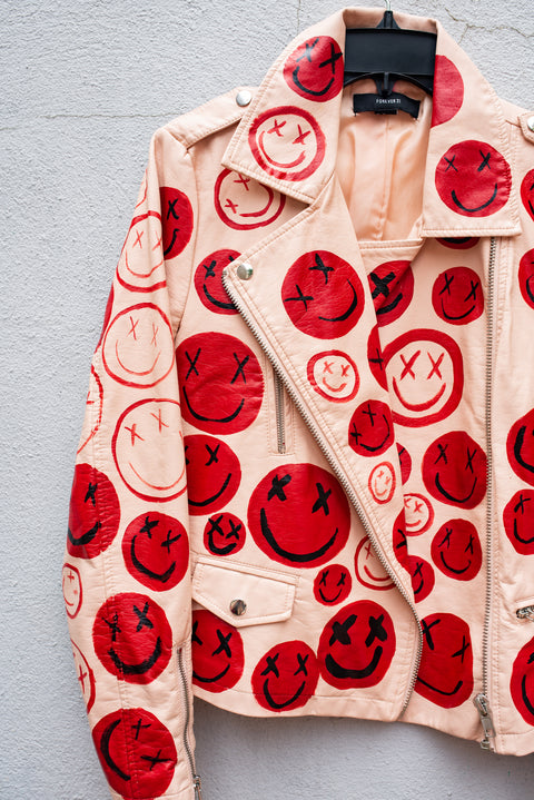 Pink leather jacket with hand-painted smiley faces.