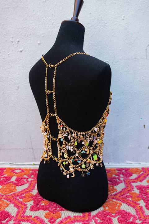 Gold chain top covered in hundreds of enamel charms.