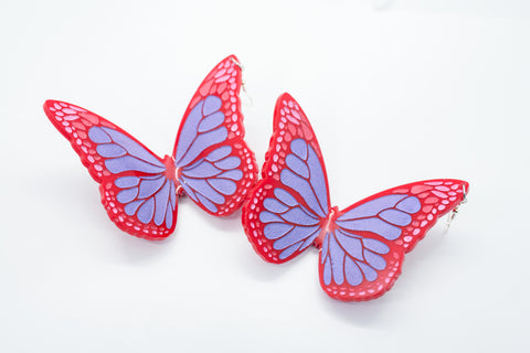 Red butterfly earrings.