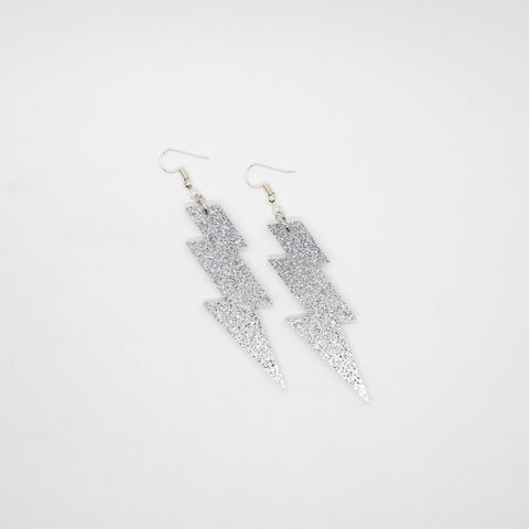 Silver glitter lightning bolt earrings by Smells Like Crime, Co.